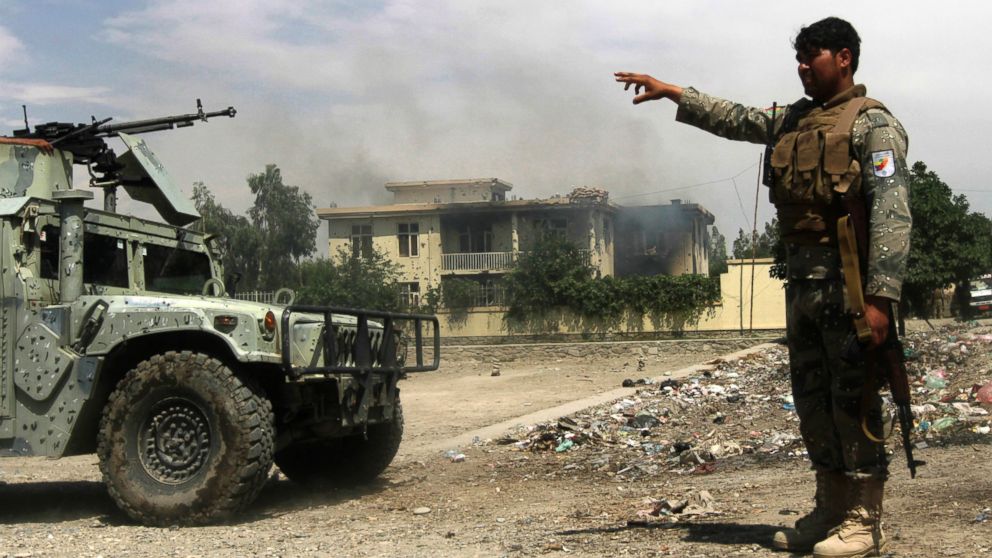 PHOTO: Afghan security forces arrive at the scene after Taliban fighters stormed a government building in Jalalabad province, May 12, 2014.
