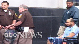 Andrew Warren is wheeled out of federal court in Norfolk, Virginia on Tuesday, April 27, 2010.