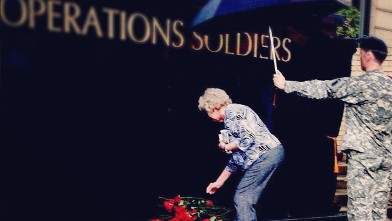 PHOTO: Woman lays down a rose
