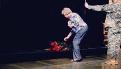 PHOTO: Woman lays down a rose