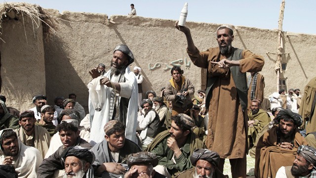 PHOTO: A man holds an empty illumination canister which residents in Panjwai, Afghanistan claim was used during Sundays killing of civilians by a U.S. soldier, during a rally at a prayer ceremony for victims on Tuesday, March 13, 2012.