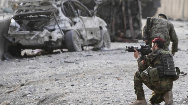 PHOTO: An Afghan soldier secures the scene of a suicide attack at the gate of an airport in Jalalabad, Nangarhar province east of Kabul, Afghanistan, Feb. 27, 2012.