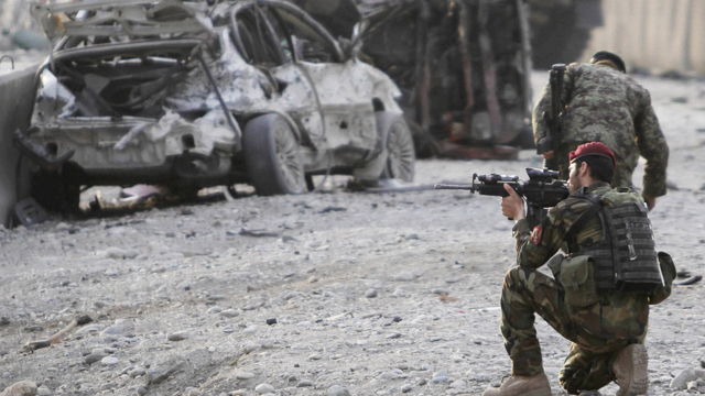 PHOTO: An Afghan soldier secures the scene of a suicide attack at the gate of an airport in Jalalabad, Nangarhar province east of Kabul, Afghanistan, Feb. 27, 2012.