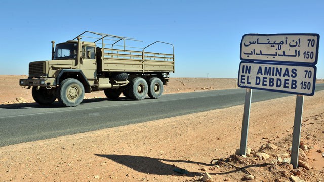 PHOTO: An Algerian military truck drives past a road sign indicating the city of Ain Amenas where hostages have been kidnapped by islamic militants at a gas plan, Jan. 18, 2013.