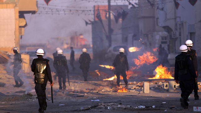 PHOTO: Riot police pursue Bahraini anti-government protesters during clashes, Jan. 27, 2012, in the eastern village of Sitra, Bahrain.