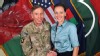 Davis Petraeus, left, shaking hands with Paula Broadwell, co-author of  