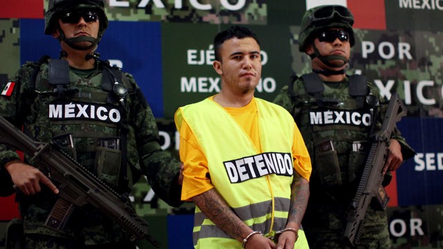 PHOTO: Army soldiers flank Daniel Ramirez, alias