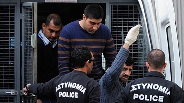 PHOTO: Riot police lead Hossam Taleb Yaacoub, a 24-year-old Swedish-Lebanese citizen, center top, to the court in the southern port city of Limassol Cyprus, March 7, 2013. The trial of a self-confessed Hezbollah member accused of preparing attacks on Isra