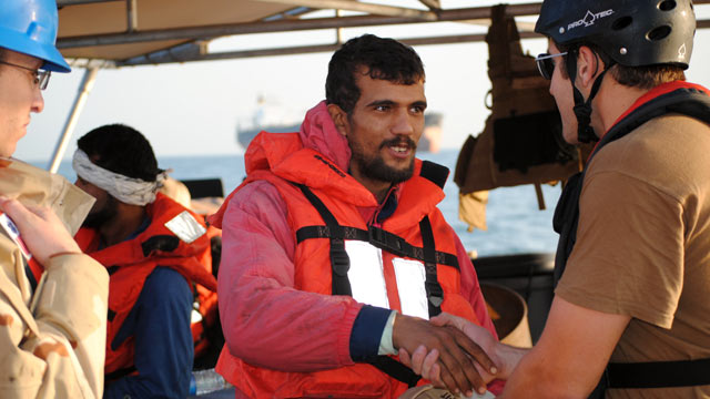 PHOTO: An Iranian mariner greets a U.S. Coast Guardsman aboard the U.S. Coast Guard Cutter Monomoy on Jan. 10, 2012 in the Persian Gulf.