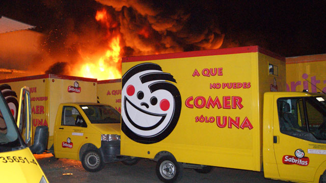 PHOTO:In this photo taken May 25, 2012, flames rise from a warehouse of the Mexican potato-chip company Sabritas, in Lazaro Cardenas, Mexico which was attacked by unidentified gunmen in what has been described as the most violent and concerted attack on a