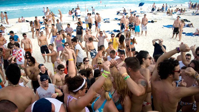 PHOTO: Spring break revelers dance at the beach in the resort city of Cancun, Mexico.