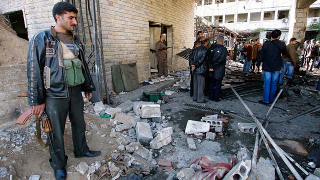 PHOTO: People stand at the site of a suicide bombing in Damascus, Syria, Dec. 23, 2011.