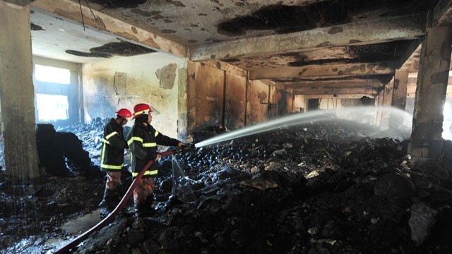 PHOTO: Bangladeshi fire-men extinguish a fire in the nine-story Tazreen Fashion plant in Savar, north of Dhaka, Nov. 25, 2012.