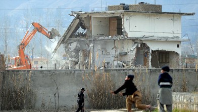 PHOTO: Young Pakistani boys play near demolition works on the compound where Al-Qaeda chief Osama bin Laden was slain last year in the northwestern town of Abbottabad, Feb. 26, 2012.