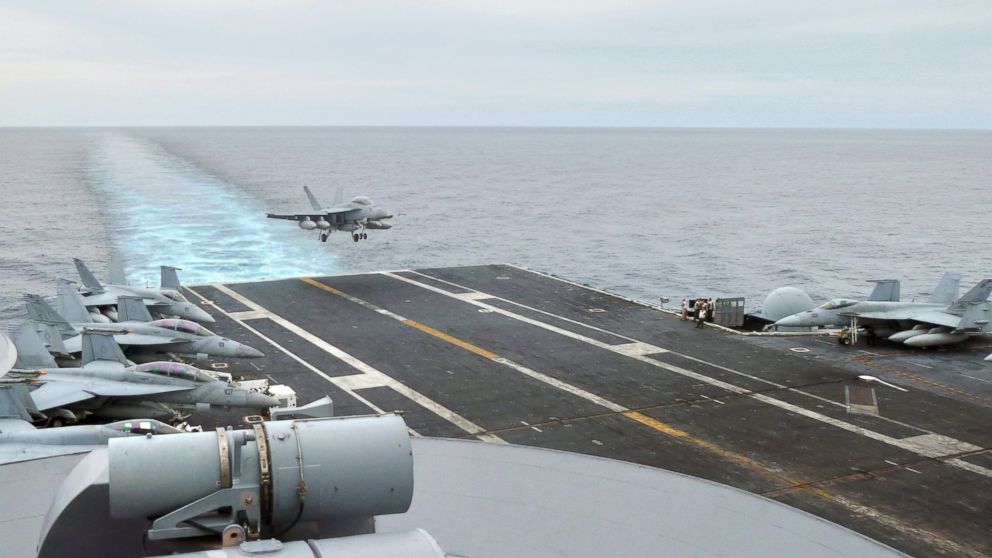 PHOTO: This photograph taken on October 24, 2013 in the South China Sea shows a US fighter jet making its landing on the USS George Washington aircraft carrier.