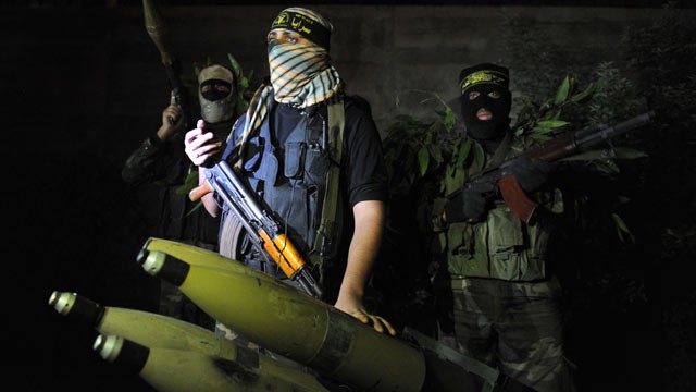 PHOTO: In a picture taken on November 25, 2012, Palestinian militants from the armed wing of the Islamic Jihad organization display rockets at an undisclosed location in the Hamas-run Gaza Strip.