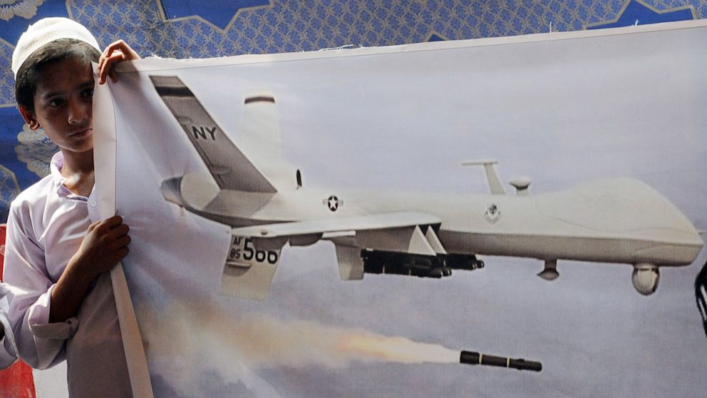 PHOTO: A Pakistani youth from outlawed Islamic hard line group Jamaat ud Dawa (JD) holds a banner of a US drone during a protest in Lahore against drone attacks in Pakistani tribal areas in Lahore in this July 5, 2013 file photo.