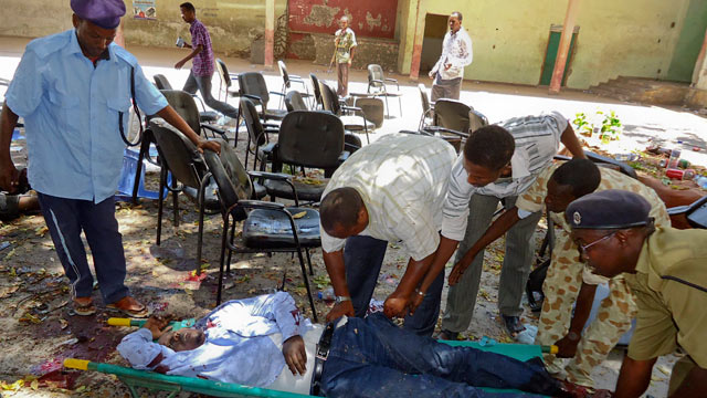 PHOTO: Somalis collect the body of a man killed in a blast at the Somali National Theater in Mogadishu, Somalia, April 4, 2012.