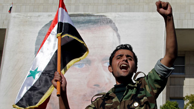 PHOTO: A Syrian soldier shouts slogans in front of a picture of President Bashar al-Assad during a pro-regime rally in Damascus in this Dec. 2, 2011 file photo.