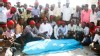 PHOTO: Fellow journalists crowd around the body of Abdisalam Hiis who was murdered in Mogadishu on December 18, 2011.