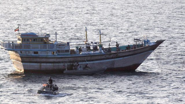 PHOTO: A Sailor aboard a safety boat observes a visit, board, search and seizure team assigned to the guided-missile destroyer USS Kidd (DDG 100) board the Iranian-flagged fishing dhow Al Molai, Jan. 5, 2012.