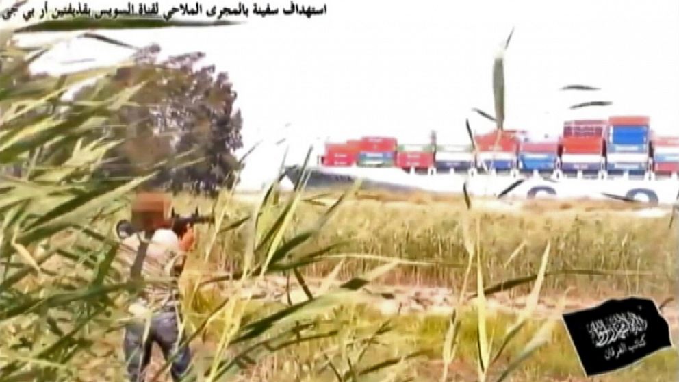 PHOTO: Person aims rocket propelled grenade launcher at ship in Suez Canal