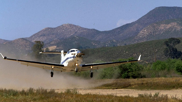 PHOTO: A U-28A plane, painted in a civilian paint scheme, is seen about to touch down on a landing strip, in this file photo.