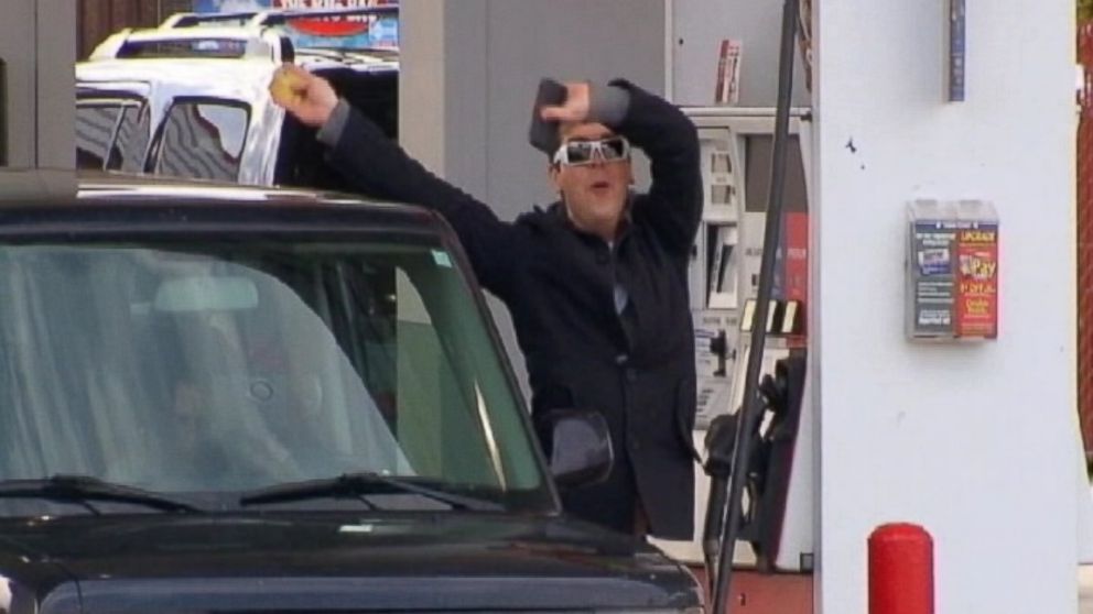 PHOTO: A driver jumps for joy as he fills his car with gas costing below $3 per gallon in Florence, Ky.