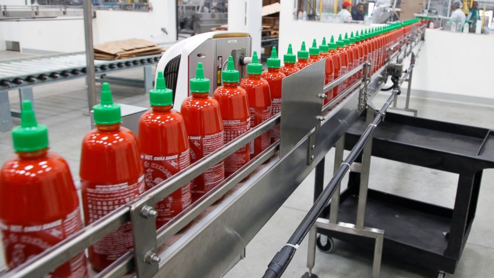 PHOTO: Sriracha chili sauce moves along a production line during at the Huy Fong Foods factory in Irwindale, Calif., Oct. 29, 2013.