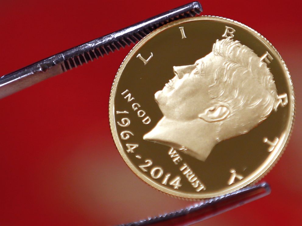 PHOTO: A newly-stamped gold coin of President John F. Kennedy is examined at the U.S. Mint at West Point on July 22, 2014 in West Point, N.Y.