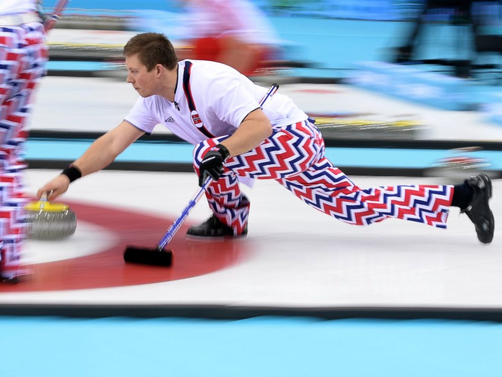 PHOTO: Norways Christoffer Svae delivers the stone during the Mens Curling Round Robin Session 10 at the Ice Cube Curling Center on Feb.16, 2014.