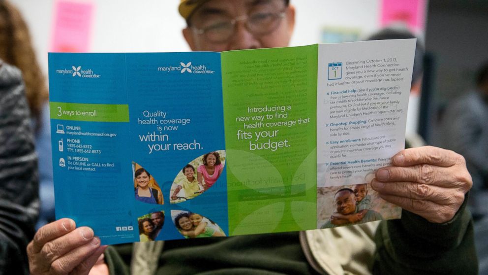 PHOTO: Sakoun Khanthanoua reads a Maryland Health Connection health insurance marketplace pamphlet while waiting to speak to a health navigator in Silver Spring, Md., Dec. 7, 2013.