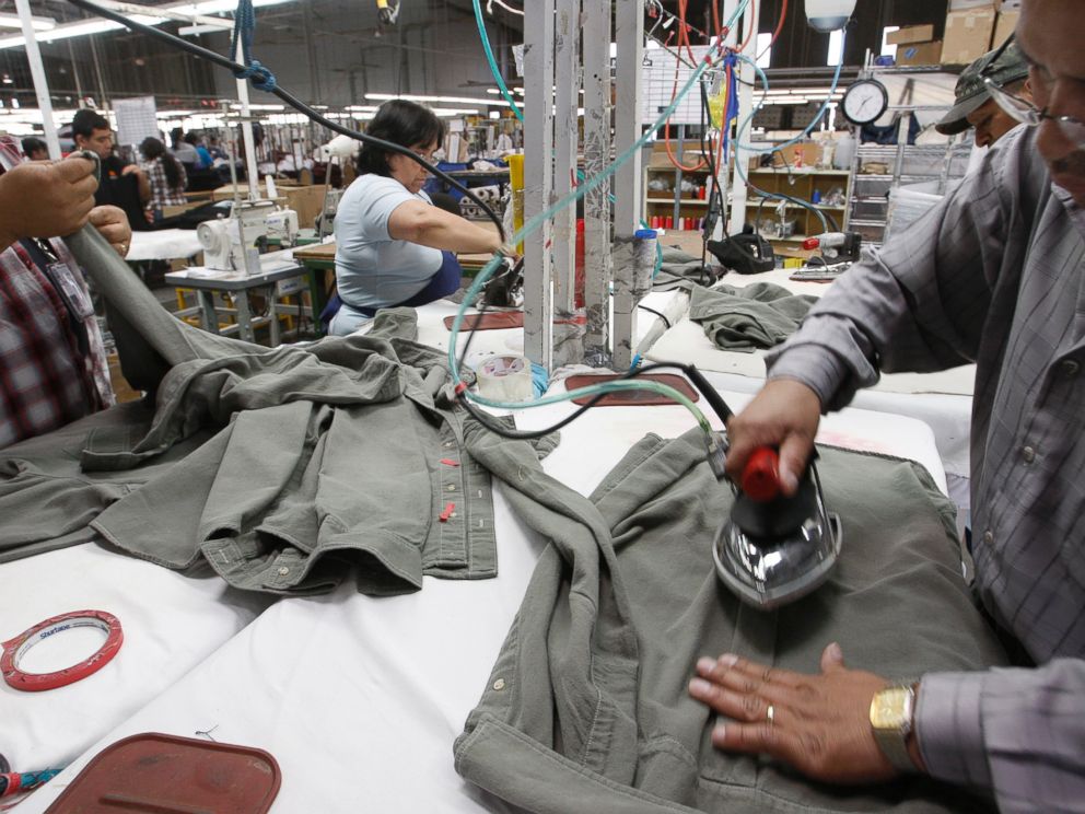 PHOTO: Workers iron shirts at the American Apparel factory in downtown Los Angeles, April 3, 2012.
