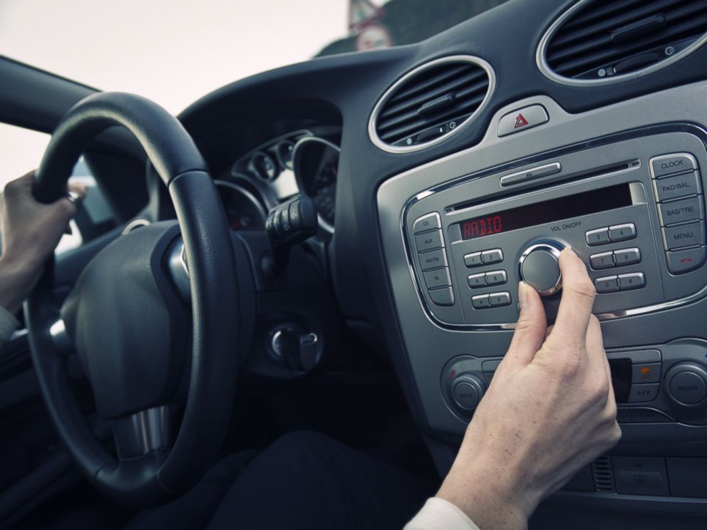 PHOTO: A man adjust the volume of a car stereo in this stock image.
