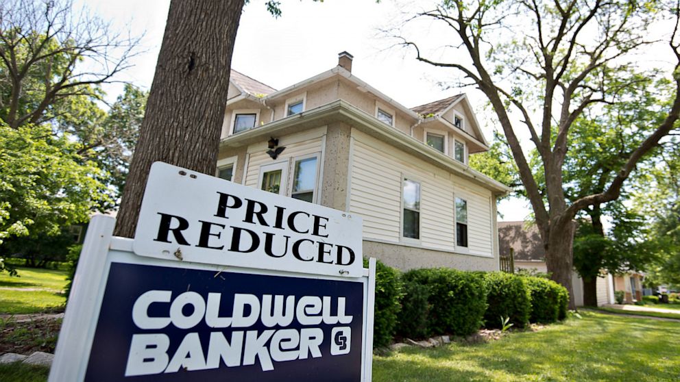 PHOTO: A "price reduced" sign stands outside a home for sale in LaSalle, Illinois, June 7, 2013.