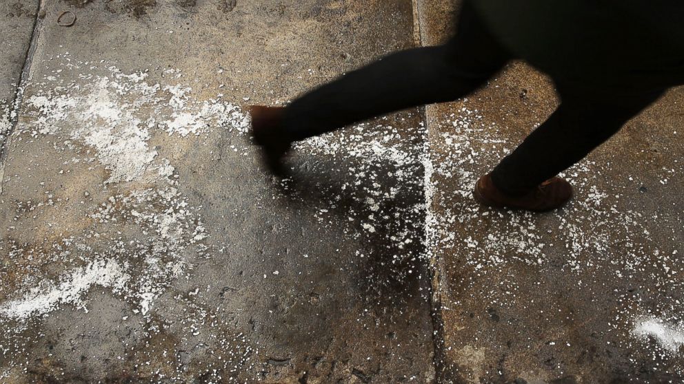 PHOTO: A person walks on a city sidewalk covered in salt, Feb. 12, 2014 in New York.