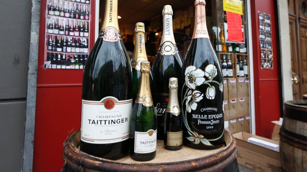 PHOTO: Various sizes of Champagne bottles are displayed in front of a wine shop in Paris, Dec. 21, 2012.