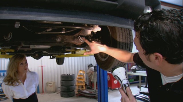 PHOTO: Mechanic Brandon Lovato of GW and Son Autobody in Oklahoma City, Okla., indicates damage to a truck bought buy the client of lawyer Kathi Rawls.