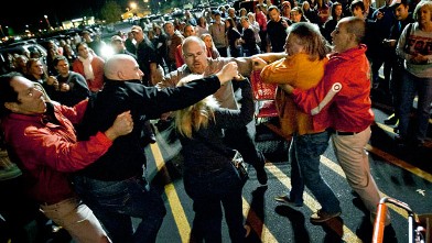 PHOTO: A crowd gathers as security guards break up a fight between shoppers waiting in line just as the doors open for Black Friday shopping at Target, Nov. 22, 2012, in Bowling Green, Ky.