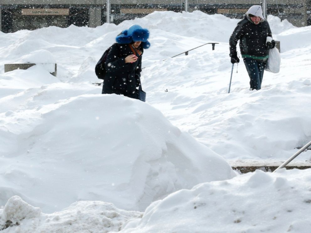 PHOTO: As snow flurries begin to fall again, pedestrians walk through Boston City Hall Plaza in Boston, Feb. 17, 2015.