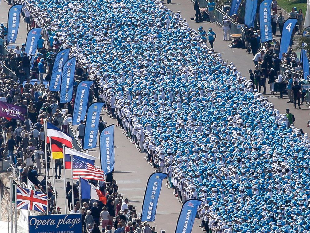 PHOTO: Employees of the TIENS Group attend a parade organized by CEO Li Jinyuan as part of a four-day celebration weekend for the 20th anniversary of his company, on the Promenade des Anglais, Nice, France, May 8, 2015.