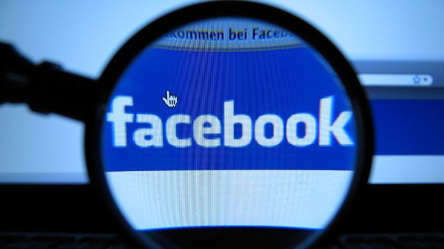 PHOTO: In this Oct. 10, 2011 file photo, a magnifying glass is posed over a monitor displaying a Facebook page in Munich.