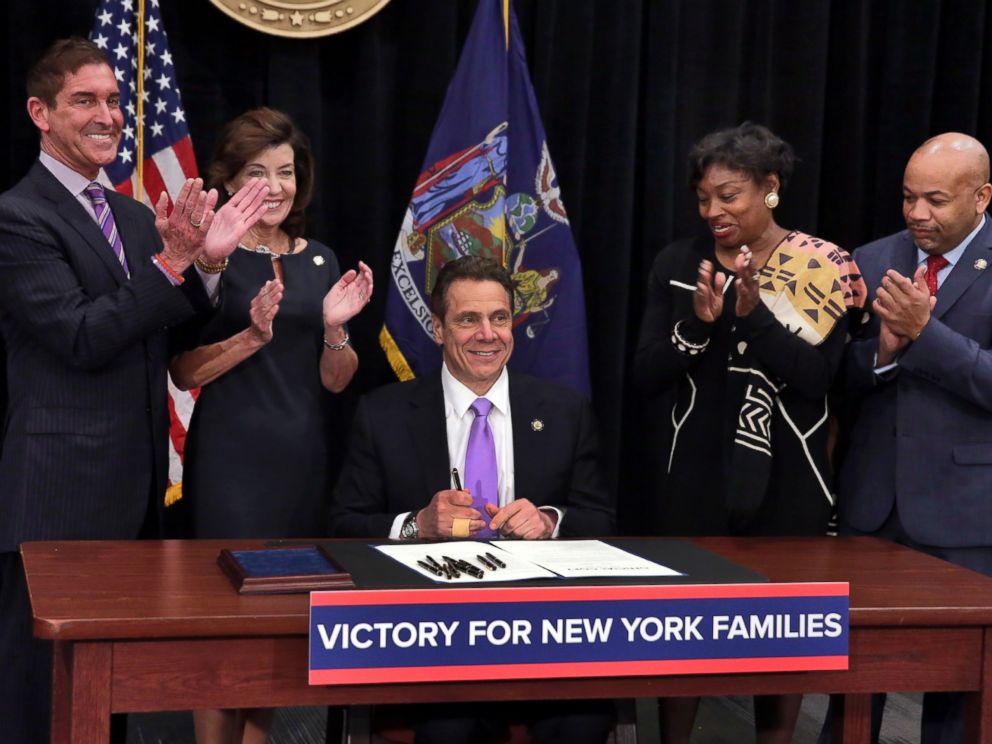 PHOTO: New York Gov. Andrew Cuomo is applauded after he signed a law that will gradually raise New Yorks minimum wage to $15 at the Javits Convention Center in New York, Monday, April 4, 2016.