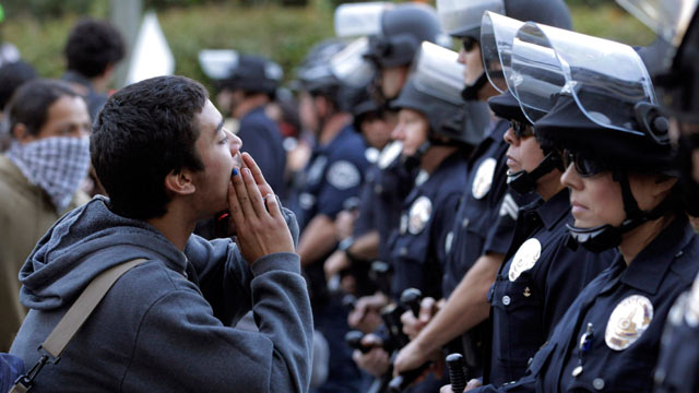 PHOTO: A protester chants his slogans in front of police officers during a rally in Los Angeles on Nov. 17, 2011.