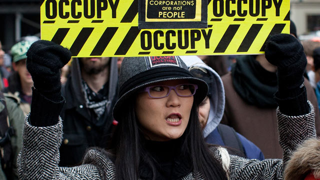 PHOTO: An Occupy Wall Street protester holds a sign during a march towards midtowns Bryant Park Feb. 29, 2012, in New York.