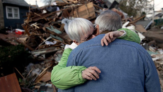 PHOTO: Sheila and Dominic Traina hug in front of their home which was demolished during Superstorm Sandy in Staten Island, N.Y., Nov. 2, 2012.
