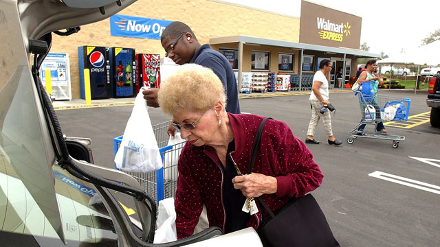 PHOTO: Michael Hall, Walmart Express customer service, helps Marian Faulkner with her bags at the new Walmart Express in Snow Hill, N.C.