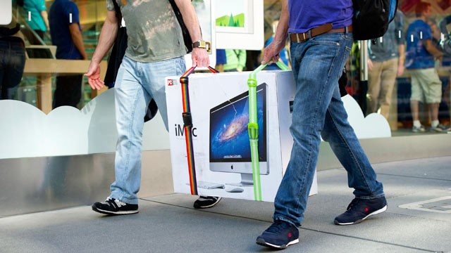 PHOTO: Customers carry an Apple Inc. iMac computer in front of an Apple Inc. store in San Francisco, Calif, April 19, 2013.