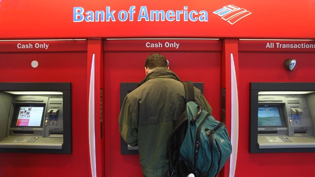 PHOTO: A man stands in a Bank of America ATM in New York City.