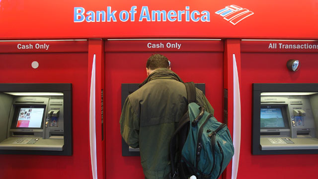 PHOTO: A man stands in a Bank of America ATM in New York City.